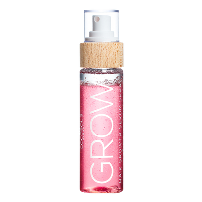 A bottle of the COCOSOLIS Grow Serum in a clear bottle showing the pink liquid with a bamboo top